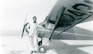 Man by a Taylorcraft Airplane
