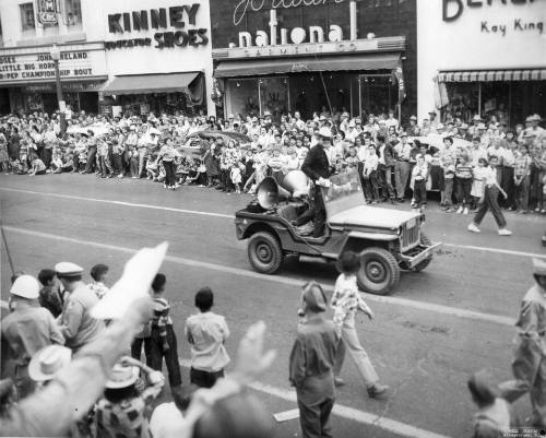 A Jeep carrying Hurley Smith, the State Fair Parade Manager