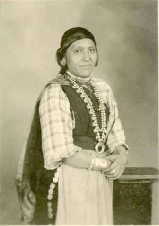 Portrait of Isleta woman wearing a large necklace with her hair pulled back
