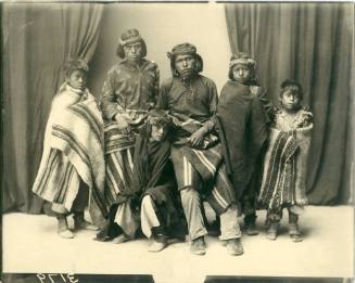 Portrait of six Zuni young men, all wearing blankets