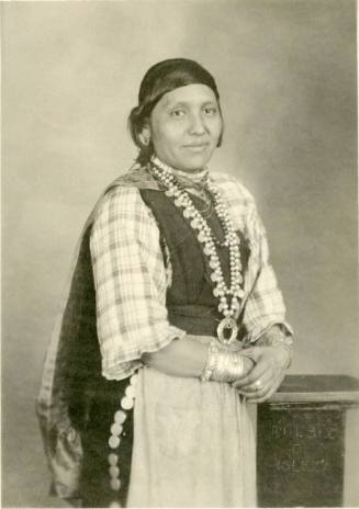 Portrait of Isleta woman wearing a large necklace with her hair pulled back
