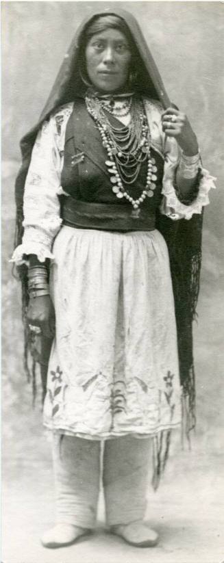 Isleta woman standing, wearing manta and jewelry