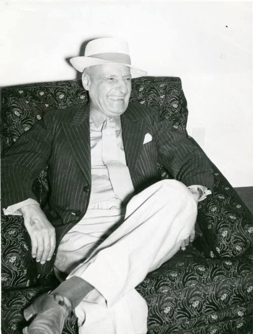 Colonel Nathan Salmon sits in an armchair
