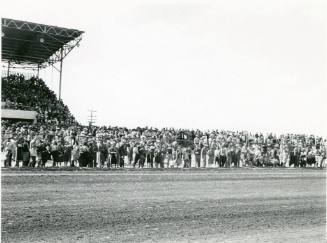 One end of the Fairgrounds grandstand and a crowd