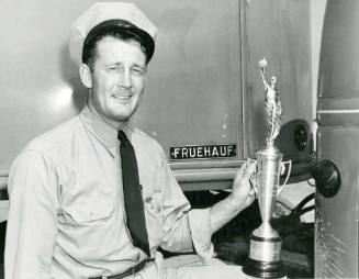 Truck Driving Competition winner holding a trophy