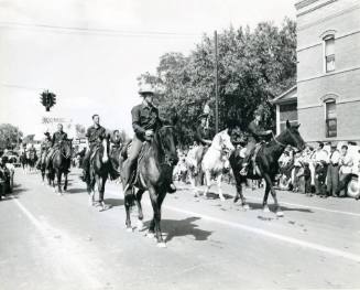 Mounted riders in State Fair Parade at corner of 8th and Central