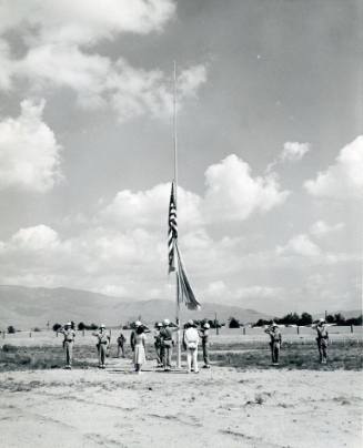 The American flag and United Nations flag are raised in a ceremony