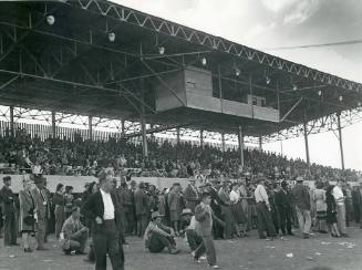 A crowd of people at the Race Track Grandstand