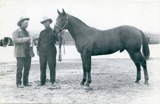 Elmer Hepin presents C. E. Hobgood with a trophy for his Champion Quarter Horse