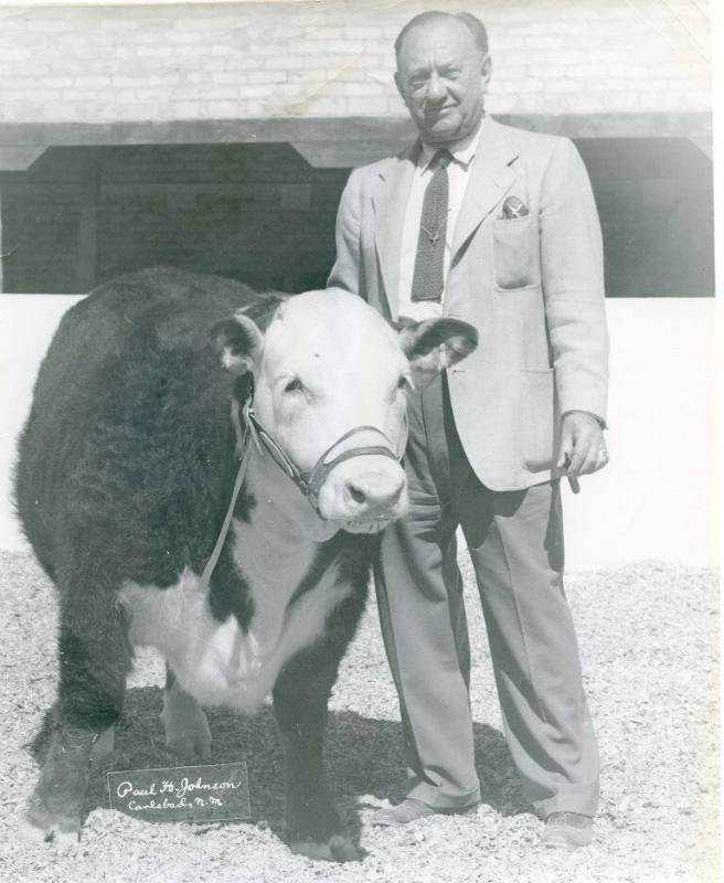Arthur Prager stands beside the Grand Champion Calf he purchased
