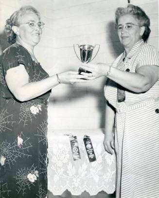 Mrs. Bertha Le Compte receives a trophy in the National Crochet Contest