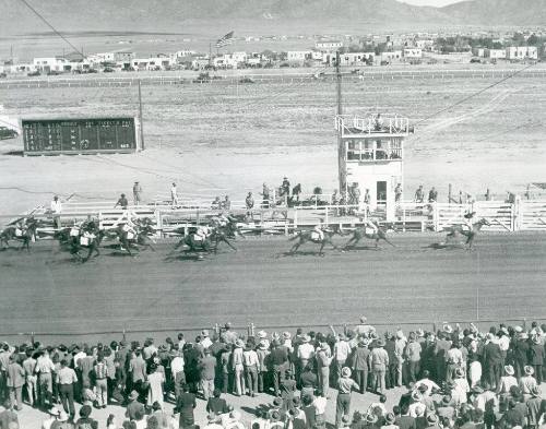 Spectators watch a horse race at the State Fair Racetrack