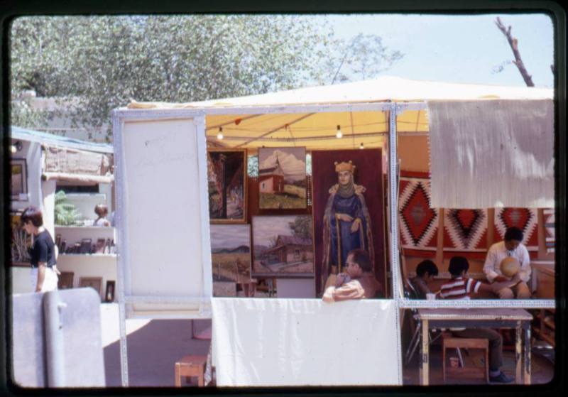 Artists in their vendor booths at an arts & crafts fair in Old Town