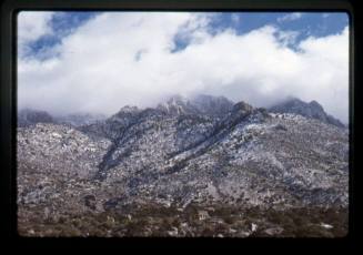 Sandia Mountains with snow and clouds