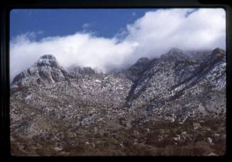 Sandia Mountains with snow and clouds
