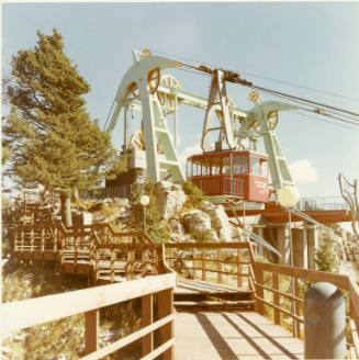 An empty gondola from the Sandia Peak Tramway parked at a loading platform