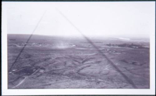 Aerial view of open land and a dust devil