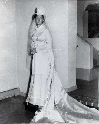 Louise Cox Marron stands in her wedding dress at a country club