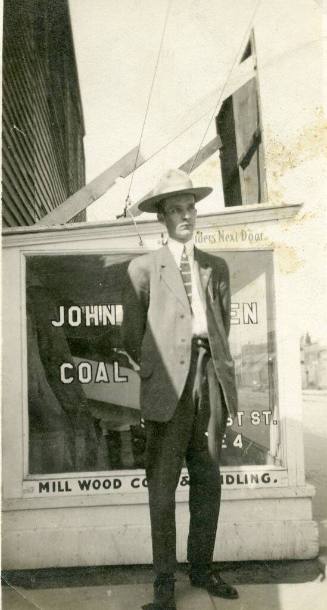 A man stands in front of the John Beaven Coal Company
