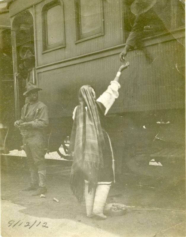 An Isleta woman sells fruit to a soldier on a passenger train