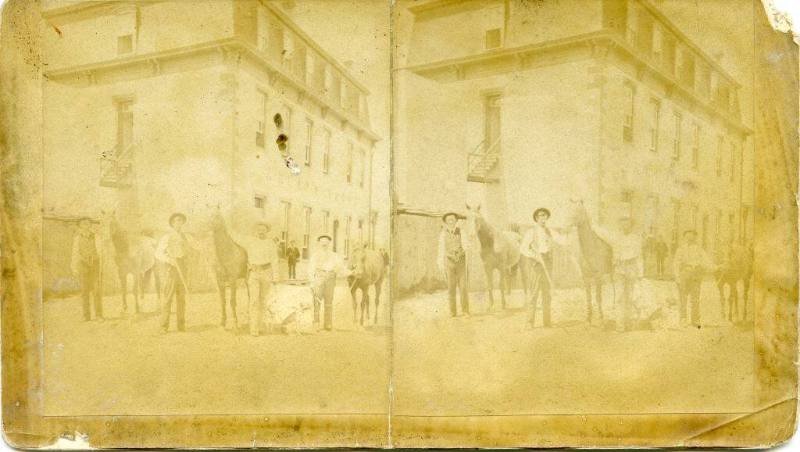 Four men with horses in front of Armijo House
