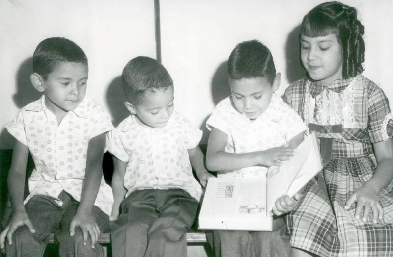 Children looking at a textbook