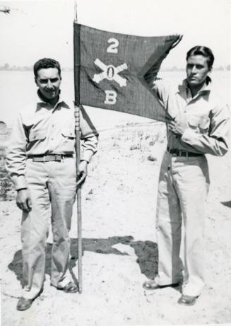 Procopio "Pete" Lucero and serviceman holding a military flag