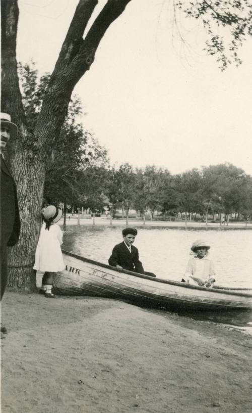 Three children with a boat