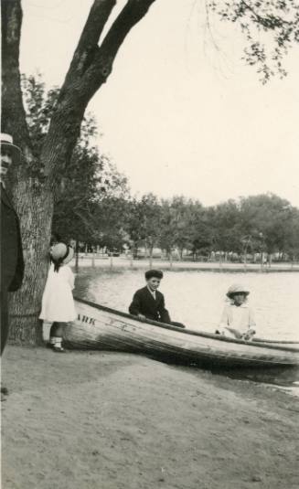 Three children with a boat
