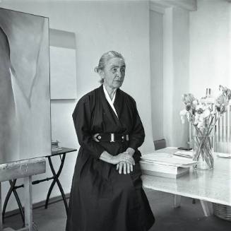 Georgia O'Keeffe seated with painting #12-A