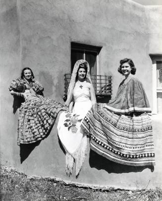 Three Women on an Adobe Wall