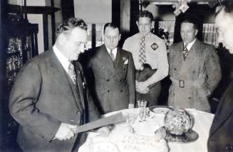 Clyde Tingley Cutting a Cake