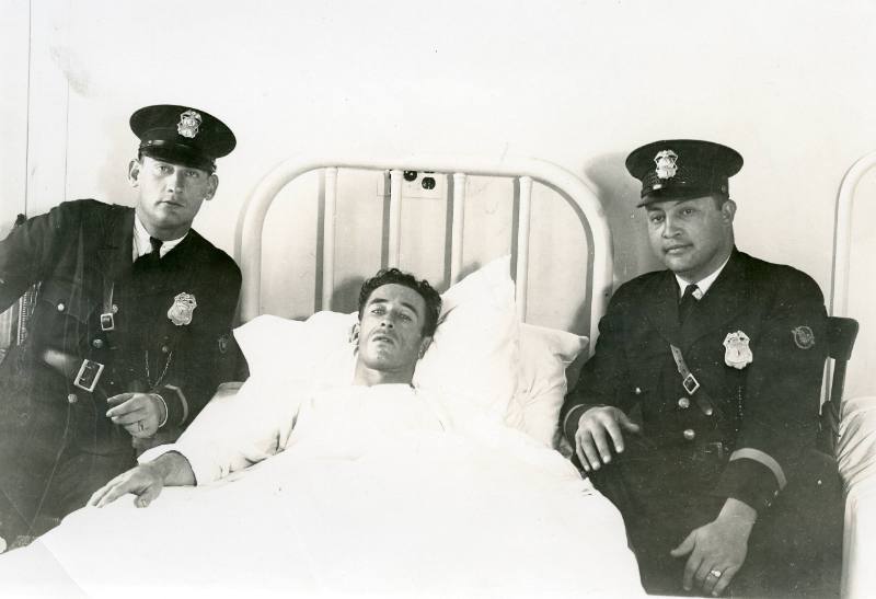 Police Officers with a Man in Hospital