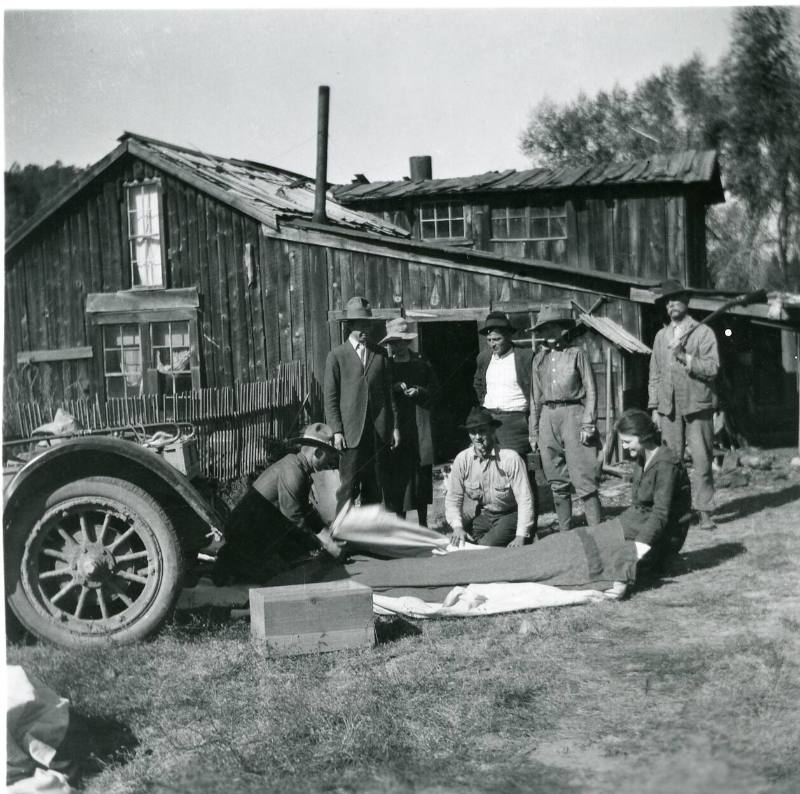 Group of People and Rustic Cabin