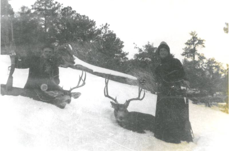 Two Hunters on a Snowy Hillside
