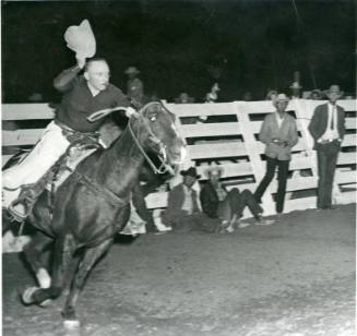 Skipper Rigdon rides around the ring at the State Fair Rodeo