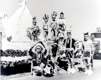 Nine Native Americans with a Little Beaver Town parade float