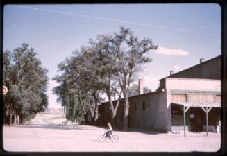 A young boy rides a bicycle in Cerillos, New Mexico