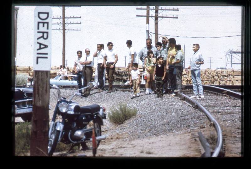 People gather on railroad tracks