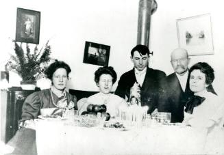 A group of people sit at a dinner table