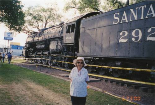 Fannie Lucero in front of Santa Fe locomotive 2926