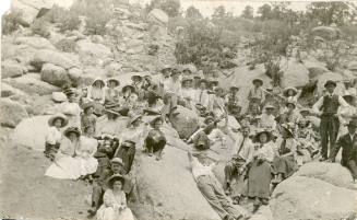 Large group of people lounging on boulders