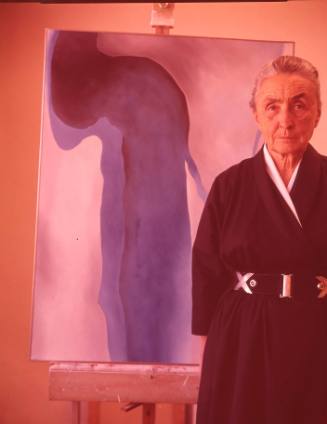 Georgia O'Keeffe with easel painting